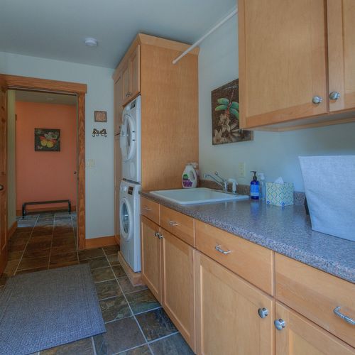 Laundry room with a Bosch stackable washer and dryer.