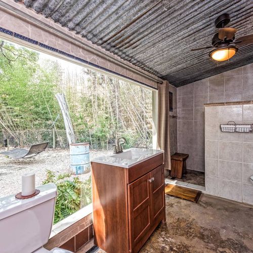 Great view from the bathroom with a curtain for privacy.  We also have an outdoor shower for your use.