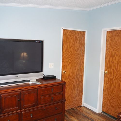 Bedroom #1 (master bedroom):  another angle showing one of the dressers, the television, the bedroom door (the door on the left), and the closet door (door on the right).