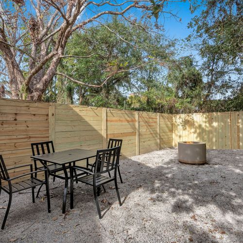 Shaded outdoor dining area surrounded by lush trees — perfect for al fresco meals.