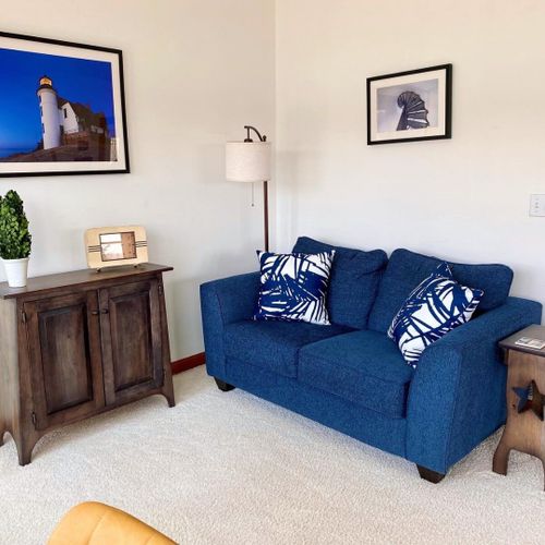 Living room:  the home has a large and lovely living room with comfy furniture, a gas fireplace, a desk, a large television with free living streaming, and great views of betsie lake!