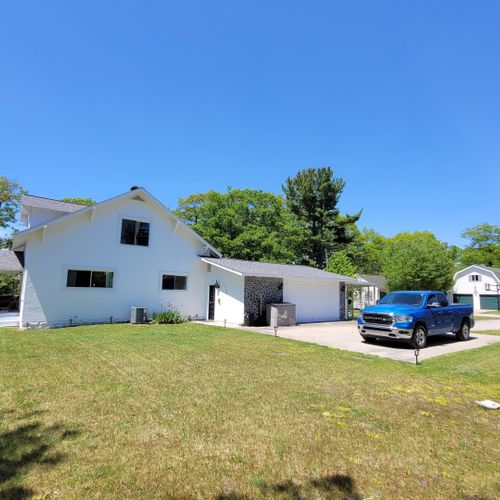 Exterior:  the side of the house, showing the large yard and parking area.
