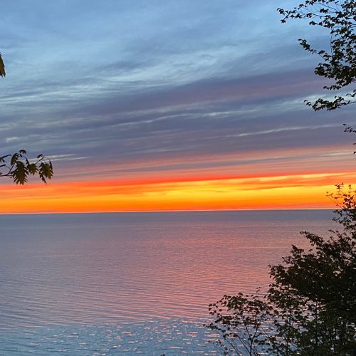 Exterior:  a beautiful sunset on lake michigan looking from the cottage.