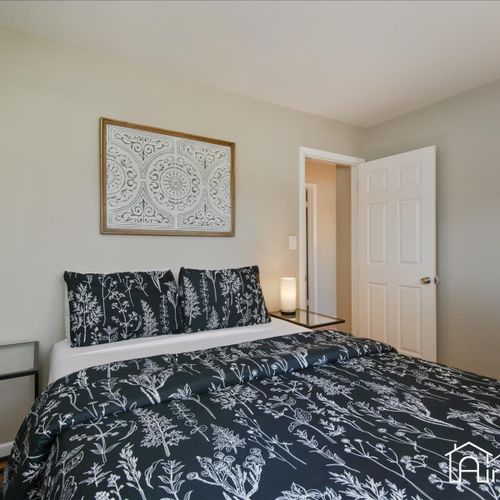 Another cozy bedroom sits upstairs with a queen bed and plenty of space to move around.