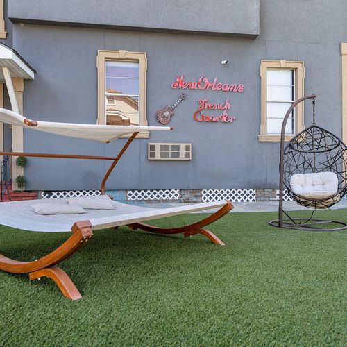 Relax in style with this cozy hammock and modern egg chair, perfect for unwinding after a day exploring the French Quarter. Your oasis awaits!