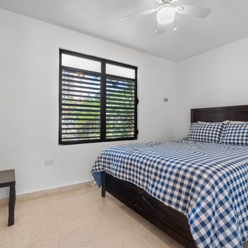 Coastal Dreams: Experience pure comfort in this inviting bedroom, featuring soothing blue accents and charming shutters for a tranquil atmosphere.