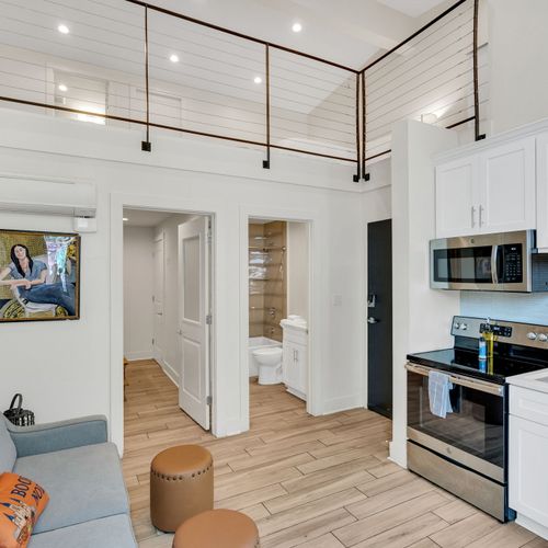 Relax in the inviting living room, complete with cozy seating and a flat-screen TV, offering a comfortable space to unwind during your stay