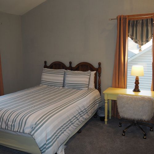 Bedroom #2 (second floor):  features a queen-size bed, desk with chair, mirror, and a large closet.