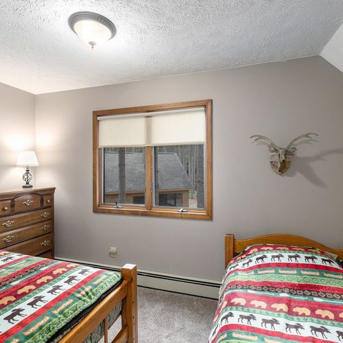 BEDROOM #4 (SECOND FLOOR):  Cute room with 2 twin beds, dresser, and a lamp.