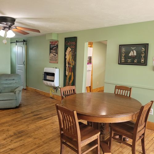 Dining room:  the dining table with the recliner in the back