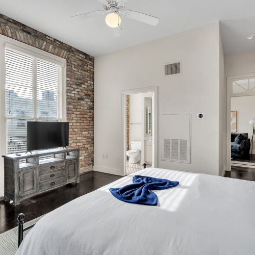 Bedroom w/ en suite access & a cozy TV setup for winding down.