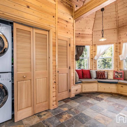 - convenient in cabin laundry with full size washer and dryer behind louvered doors
- nearby wraparound bench offers a cozy corner for reading, relaxing, or socializing
- natural wood and slate tile flooring add warmth & rustic elegance to the space