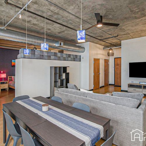 - gather around the long dining table under colorful pendant lights for meals or meetings
- modern living room with sectional and smart tv offers space to unwind in style
- open layout connects dining, lounging, and sleeping areas seamlessly