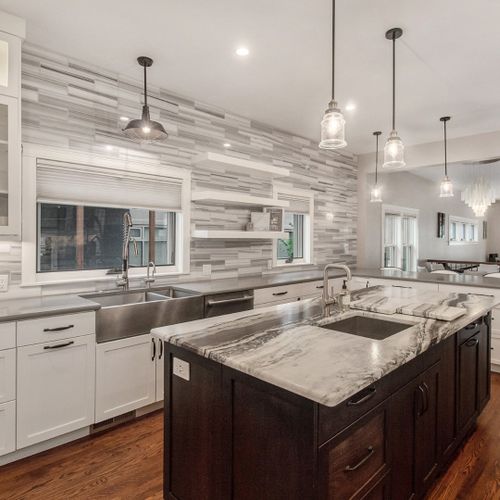 This gourmet kitchen boasts jenn air appliances, large center island, wolf gas cooktop, kitchen and prep sinks, separate bar area with beverage refrigerator and walk-in pantry which provides the perfect space for culinary creativity and entertaining.