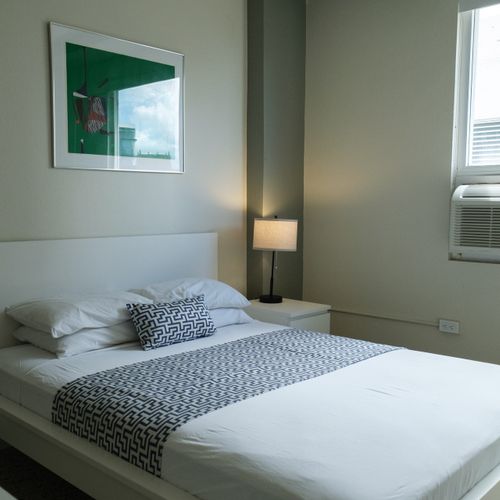 Your tranquil escape awaits! This bright, inviting bedroom features a plush queen-sized bed, crisp linens, and ample natural light, ensuring a restful night's sleep after a day of exploring.