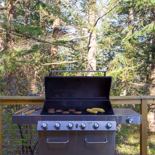 Gas grill with an extra tank and tools. Just bring your secret sauce!
