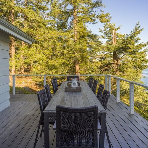 Outdoor seating for twelve guests right outside the dining room makes dining al fresco easy.