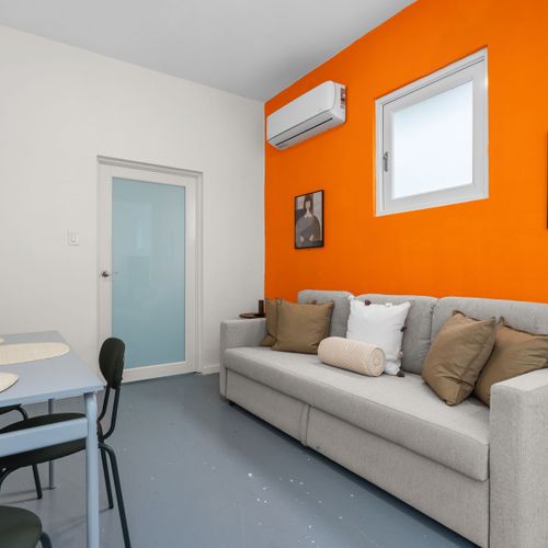 Bright living area with inviting seating, flat-screen TV for movie nights, and a coffee table for snacks or drinks.