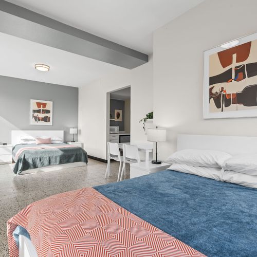 Immerse yourself in a relaxing atmosphere within this stylish bedroom, adorned with subtle artistic touches that create a unique and inviting space.