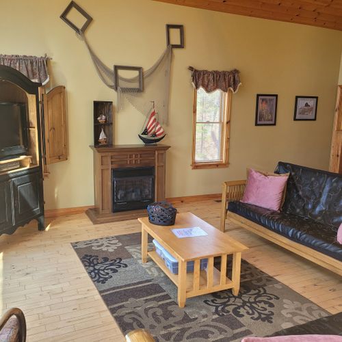 Living room:  gorgeous living room with 2 futons, an electric fireplace, and a lovely view of long lake!
