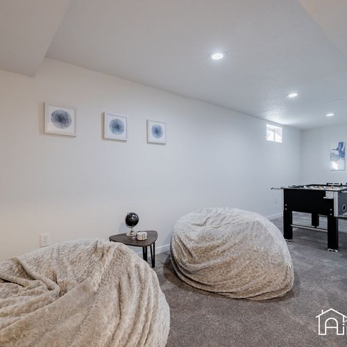The downstairs game room includes a foosball table, extra large bean bag chairs, and tons of board games!