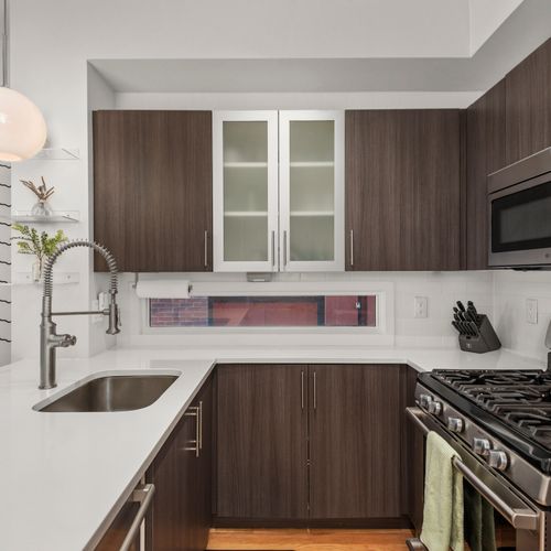 Bright modern kitchen with quartz countertops, sleek cabinetry, and plenty of prep space