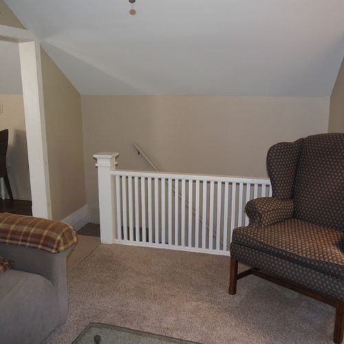 Living room:  very comfortable living room with sofa, coffee table, chair, lamp, and window a/c unit.