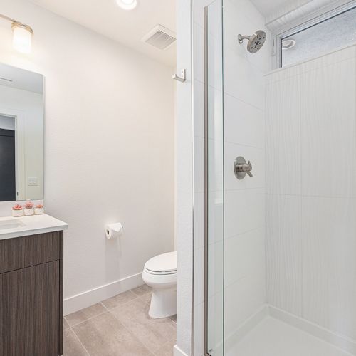 A thoughtfully designed compact bathroom with ample lighting for a fresh feel.