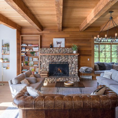 Living room seating with fireplace, and shelf of books and games