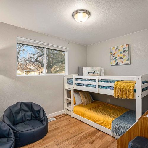 This bunk bedroom features with two twin sized beds, ideal for accommodating children or additional guests.