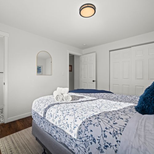 Sunlit bedroom offering a calm, spotless space to relax and recharge.