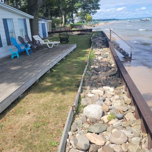 Exterior:  the private deck, beach, fire pit, and lakefront at the beach house.