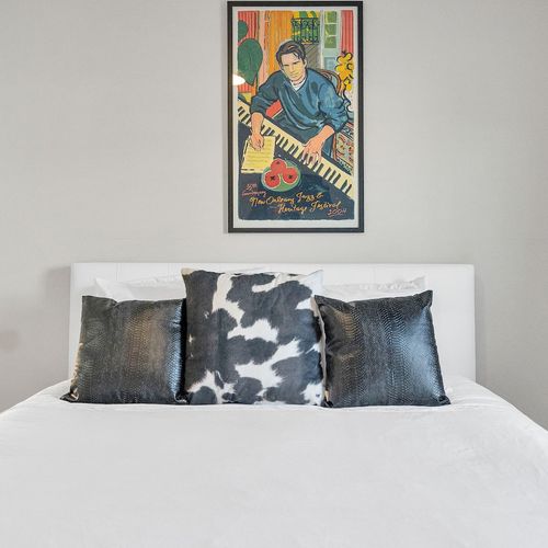 Bold patterned bedding & vibrant art make this room full of personality.