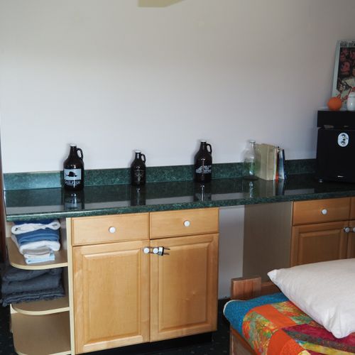 Living room #2 (lower level):  features a sofa and loveseat, bar area, and 3 single beds.