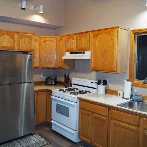 Kitchen:  full kitchen with all modern appliances including a microwave, toaster, coffee maker, and dishwasher. Also includes lots of cabinet space and a good supply of cooking and dining utensils.