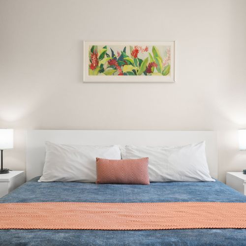 Every detail in this bedroom is designed with your comfort in mind, from the soothing decor to the convenient bedside amenities, making your stay seamless and pleasant.