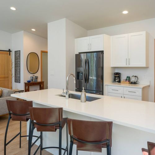 The kitchen flows right into the living room, just a few steps away—perfect for staying connected while cooking or relaxing together.
