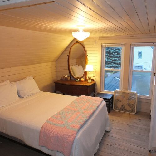 Bedroom #3 (second floor):  features a full-size bed, baby crib, dresser, mirror, and closet.