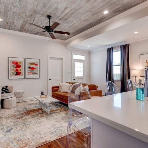 Bright, airy living room w/ warm tones & stylish decor to unwind after a long day.