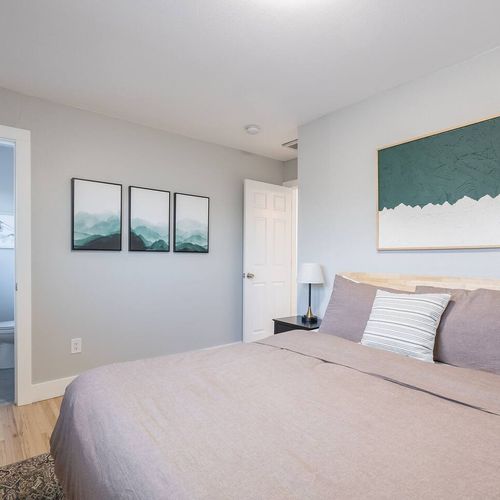 - sleep peacefully in a cozy, well lit room featuring calming tones and soft textures
- enjoy the convenience of a private bathroom just steps away from your bed
- modern green art and plush bedding create a fresh, peaceful retreat
