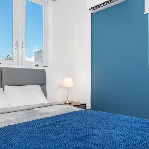 Modern renovated bedroom, huge double bed, soft bedding, bright, window views, airconditioner, modern table lamps