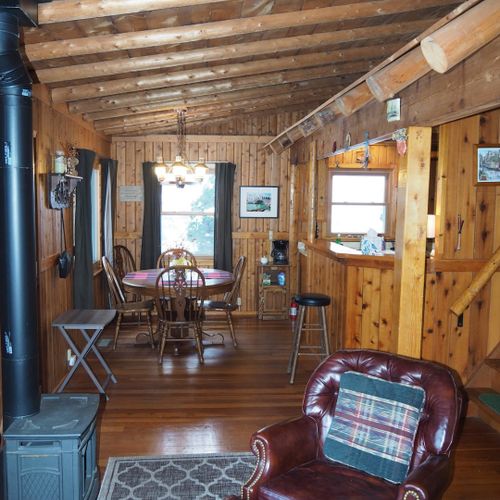 Living room:  the cabin has a very cozy and comfortable living room with a sofa, comfy chair, desk, book cabinet, gas fireplace, and a television with live streaming via roku.