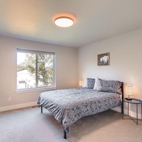 - queen bedroom with subtle floral bedding and soft lighting for restful sleep