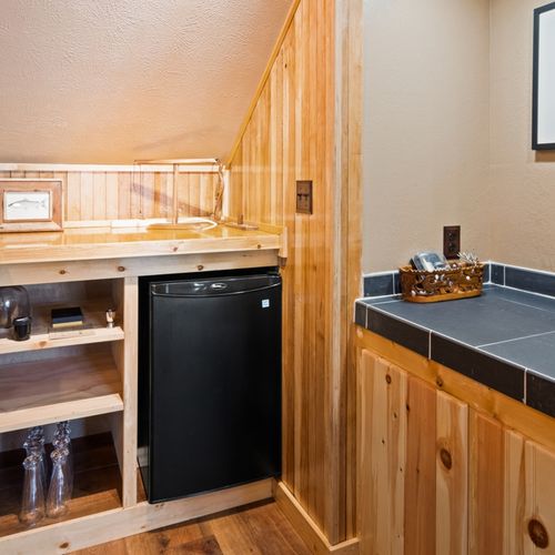 Lower level:  great family space in the lower level with dining table, wet bar, games, sofa, and television.