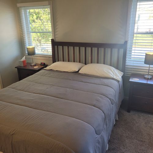 Bedroom #1:  features a queen-size bed, private en suite full bathroom, private television, walk-in closet, dresser, mirror, nightstands, and lamps