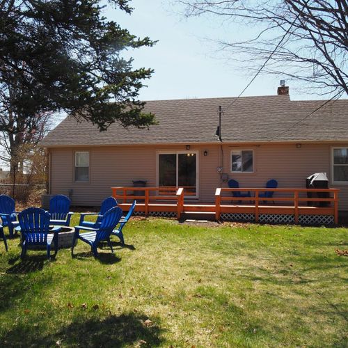 Exterior:  nice view of the backyard, including the back deck, gas grill, and fire pit.