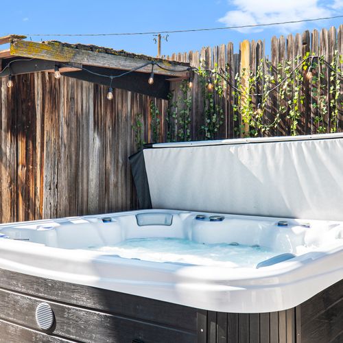 Sink into the hot tub, steam rising, tension dissolving in every season.