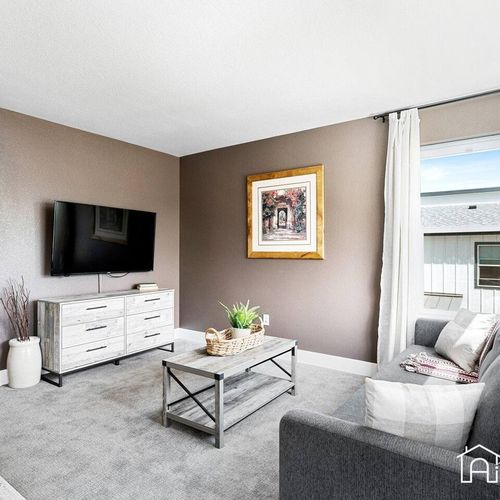 - enjoy movie nights or quiet mornings in this intimate lounge with a modern sofa and smart tv
- framed artwork and earth toned walls create a grounded and comfortable feel
- light filters in through sliding glass doors to keep it bright and airy