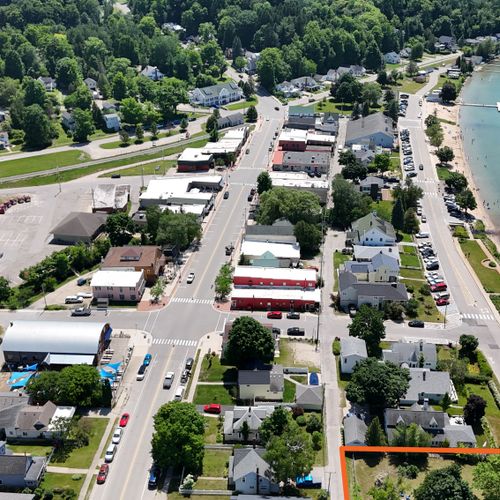 EXTERIOR:  The south end of the property is shown in orange with the public boat launch, fishing pier, and Beulah Beach  to the south of the property and downtown Beulah in the upper middle portion of the photo.