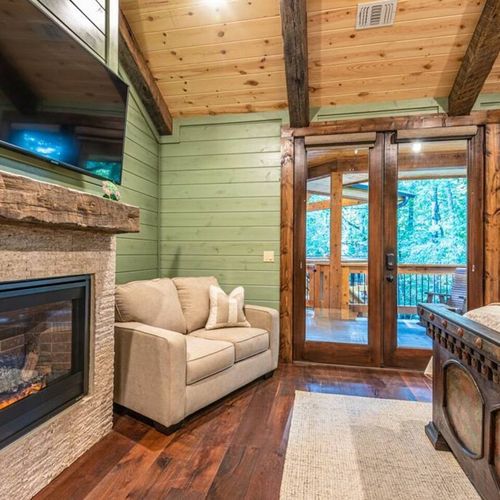A twin sleeper sofa and fireplace along with a Smart TV.
